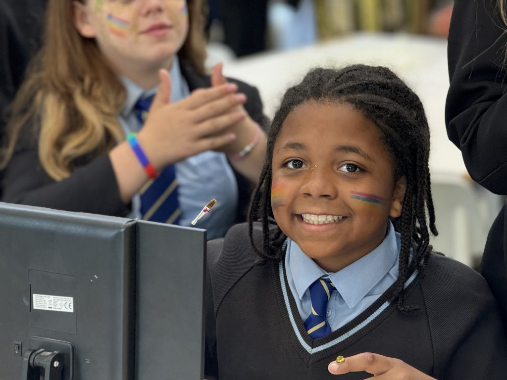 PSHE smiling student at the PC at Bishop Perowne School