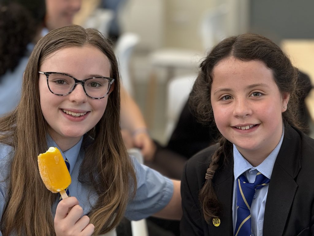 two students, one eating an ice cream